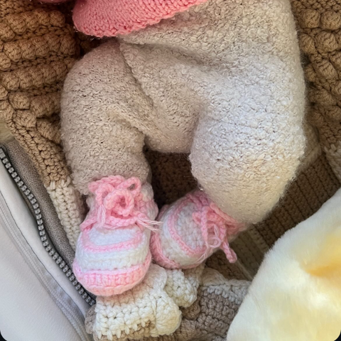 HOPPI crochet baby shoes worn by a baby