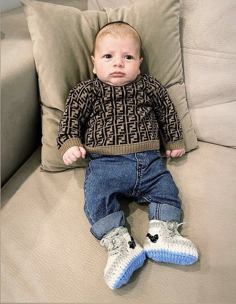 HOPPI crochet baby shoes worn by a baby